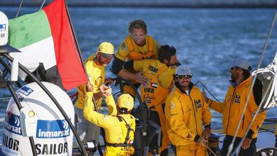 Crew members onboard Abu Dhabi Ocean Racing's Azzam begin to celebrate winning the first leg of the Volvo Ocean Race on Wednesday in Cape Town. Nic Bothma / EPA