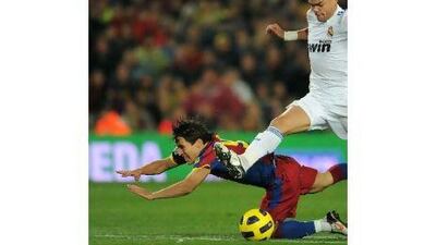 Bojan Krkic, left, of Barcelona fights for the ball with Pepe of Real Madrid in a 5-0 rout by Barcelona. A reader claims that Barcelona are invincible and Madrid must now resort to defence and counter-strikes.