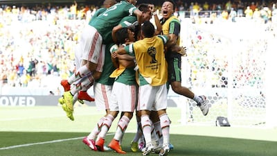 Mexico players celebrate their goal against the Netherlands on Sunday at the 2014 World Cup. Marcelo Del Pozo / Reuters