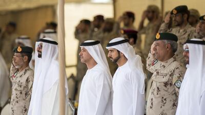 Sheikh Hazza bin Zayed, Vice Chairman of the Abu Dhabi Executive Council, Sheikh Hamdan bin Mohammed, Crown Prince of Dubai and Lt Gen Hamad Al Romaithi, Chief of Staff UAE Armed Forces, inspect military personnel during a parade marking 40th anniversary of the UAE Armed Forces unification, and the graduation ceremony for the 5th batch of National Service personnel, at the Seeh Al Hama camp. Rashed Al Mansoori / Crown Prince Court - Abu Dhabi