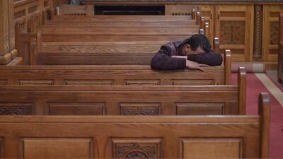 A man mourns the victims during an early morning ceremony at the Prince Tadros church in Egypt's Minya province. AFP