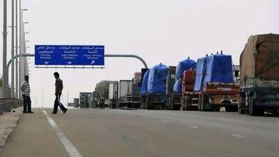 A line of trucks waits to cross the Ghweifat border into Saudi Arabia. Ryan Carter / The National