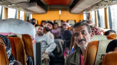 Members of Syria’s Bedouin community ride on a bus after being evacuated from southern Sweida province. AFP
