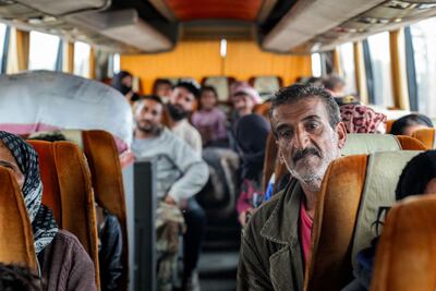 Evacuating members of the Bedouin community ride a bus stopping at a security checkpoint in Taarah, in Syria's southern Sweida. AFP