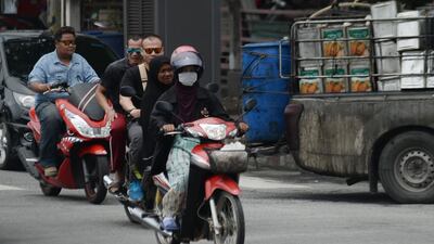 A motorist wears a face mask during a commute through Thailand's south province of Narathiwat. AFP