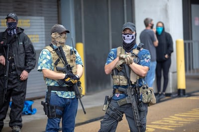 Armed members of the Boogaloo movement in Hawaiian shirts at an open-carry gun rights rally. Getty Images