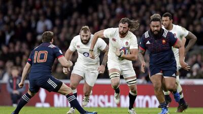 Tom Wood of England in action with Camille Lopez of France. Henry Browne / Action Images