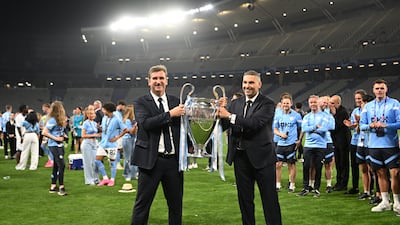 Khaldoon Al Mubarak, right, and Ferran Soriano celebrate with the European Cup on the pitch. AFP