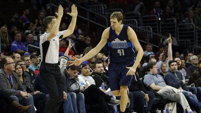 Dirk Nowitzki celebrates after scoring a basket during the second half against the Philadelphia 76ers. Matt Slocum / AP Photo