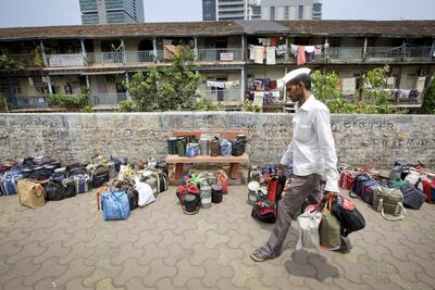 The dabbawalas collect packed meals from clients' homes and deliver them to their offices. AP