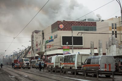 Smoke rises above a multi-story shopping centre in the Siberian city of Kemerovo, about 3,000 kilometres east of Moscow. Sergei Gavrilenko / AP Photo