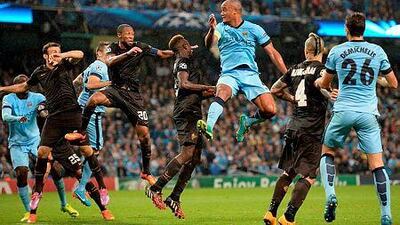 Manchester City's Belgian defender Vincent Kompany, centre, heads the ball during the Uefa Champions League Group E football match against Roma in Manchester, Northwest England, on September 30, 2014. The match ended 1-1. AFP PHOTO/OLI SCARFF