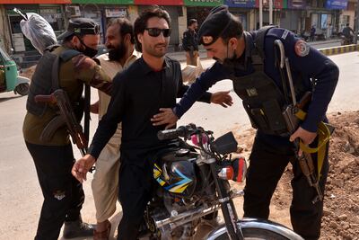 Pakistani security officials check people and vehicles at a checkpoint in Peshawar. EPA