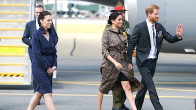 Prince Harry, Duke of Sussex and Meghan, Duchess of Sussex walk with Prime Minister Jacinda Ardern after arriving at the Wellington International Airport Military Terminal. Getty Images