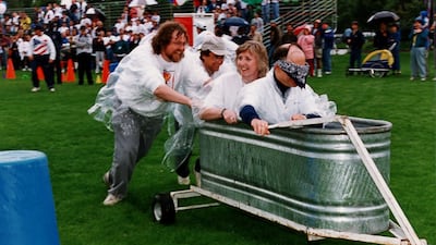 September 18, 1996: Microsoft employees Nathan Myhrvold and Mike Murray push Christine Betts and Moshe Dunie in the dryland yacht races at the Microsoft Giving Games. Photo: Micosoft
