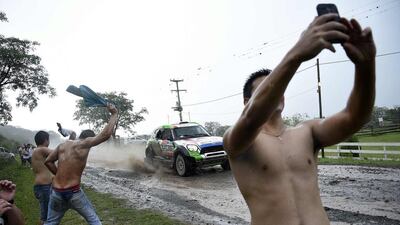 Spectators cheer and take selfies as driver Erik Van Loon and co-driver Wouter Rosegaar, both from the Netherlands, compete in the Stage 3 of the 2016 Dakar Rally between Termas de Rio Hondo and Jujuy, Argentina, on January 5, 2016. Franck Fife / AFP