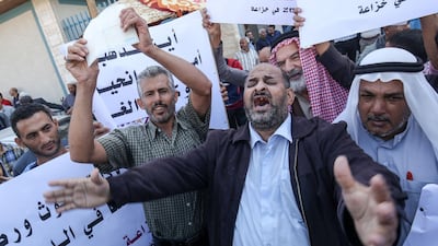 Demonstrators attend a protest calling on relief agencies to repair Palestinian homes damaged during the 2014 Israel–Gaza conflict, in the Khuza'a village in the eastern part of Khan Yunis in the southern Gaza strip. AFP