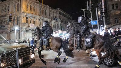 Israeli mounted policemen ride during the clashes. AFP