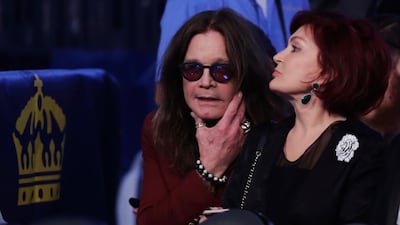 Ozzy Osbourne, left, and his wife Sharon wait for the super welterweight boxing match. AP