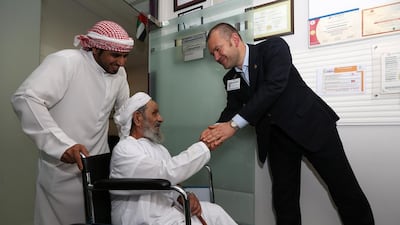 Dr Zbigniew Brodzinski, right, an orthopedic surgeon, and Omani patient Hamdan Sulaiman. Pawan Singh / The National
