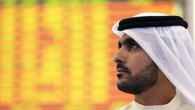 An Investor looks at the screen at the Dubai International Financial Market in Dubai. Reuters