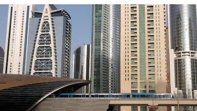 Jumeirah Lake Towers, seen in the background, are connected by a footbridge to the JLT Metro station on Sheikh Zayed Road in Dubai. The station, however, has not yet open to passengers.