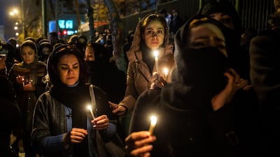 Demonstrators hold candles while gathering during a vigil for the victims of the Ukraine International Airlines flight that was unintentionally shot down by Iran, in Tehran, Iran. Bloomberg