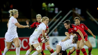 England, in white, taking on Canada during the World Rugby Women's Sevens Series at the Rugby Sevens grounds in Dubai on December 4, 2014. Satish Kumar / The National