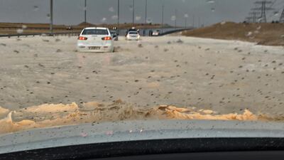 Brian Kleiver, an American living in Abu Dhabi, had to push his car to higher ground after his car got stuck in rainwater. Courtesy Brian Kleiver