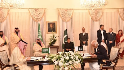Imran Khan and Mohammad Bin Salman look on as the officials sign deals in Islamabad. EPA