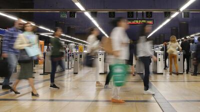 Commuters walk at Camartin’s metro station in Madrid, Spain. Ballesteros / EPA