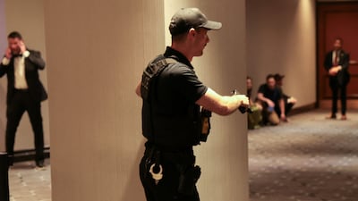 A Secret Service agent holds his gun as a shooter opens fire during the annual White House Correspondents' Association dinner in Washington, D. C. , U. S. , April 25, 2026. REUTERS / Jonathan Ernst
