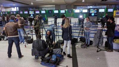 Reporters gather in front of the EgyptAir counter at Charles de Gaulle Airport. An EgyptAir flight from Paris to Cairo carrying 66 people disappeared from radar early Thursday morning. Raphael Satter / AP