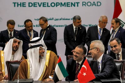 UAE Minister of Energy and Infrastructure Suhail Al Mazrouei and Turkey's Transport Minister Abdulkadir Uraloglu, right, chat during the signing of the Development Road framework agreement in Baghdad in 2024. EPA