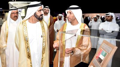 Sheikh Mohammed bin Rashid, Vice President and Ruler of Dubai, looks at the UAE flag that was carried to the moon by Apollo 17 in 1973. Wam