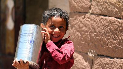 A Yemeni child receives humanitarian aid, donated by the World Food Programme in the city of Taez, on October 10. Ahmad Al Basha / AFP