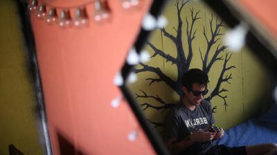 Gustavo Gatica, 22, a Chilean student blinded in both eyes by police rubber bullets in a protest last year, plays with a cube in braille system inside his house in Santiago, Chile. Reuters