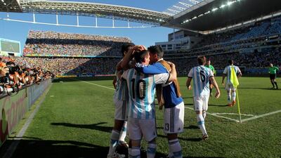 Angel di Maria of Argentina celebrates with teammates after scoring the 1-0 winner against Switzerland on Tuesday at the 2014 World Cup. Julian Finney / Getty Images