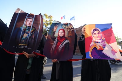 Protesters hold portraits of Mahdieh Esfandiari, who was arrested in France in February, during a rally calling for her release, outside the French embassy in Tehran, in October 2025. AFP