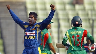 Sri Lanka’s Chaturanga de Silva, left, celebrates taking the wicket of Bangladesh’s Mushfiqur Rahim during their Asia Cup match in Dhaka, Bangladesh, on March 6, 2014. AM Ahad / AP Photo