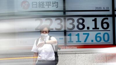 A man stands in front of an electronic stock board at a securities firm in Tokyo. Typical mistakes investors make include trying to time the market. Associated Press