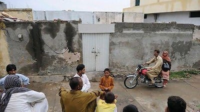 People gather outside the house of a Christian girl, arrested on charges of blasphemy, in the slum neighbourhood of Mehrabad in Islamabad. The girl’s mother and sister were beaten and a lynch mob surrounded the home following claims she burned pages of the Holy Quran.