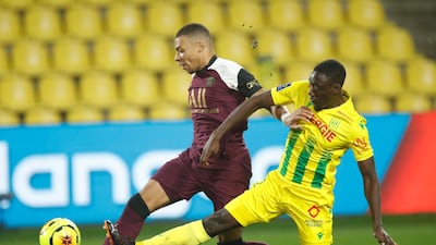 PSG's Kylian Mbappe in action with Nantes' Dennis Appiah. Reuters