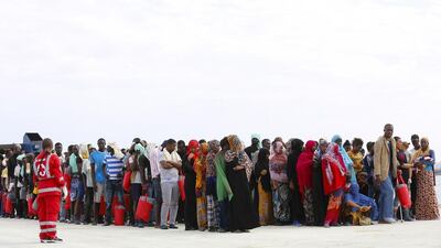 Migrants wait on the dock after disembarking from a Medecins Sans Frontieres ship carrying 320 migrants in the Sicilian harbour of Augusta, Italy, on August 25, 2015. Antonio Parrinello / Reuters