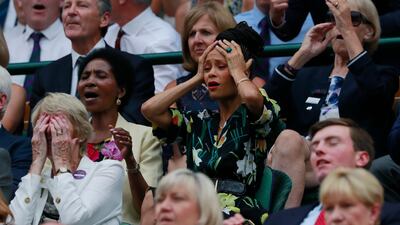 Actress Thandie Newton, centre, watches the men's singles semi-final match AP