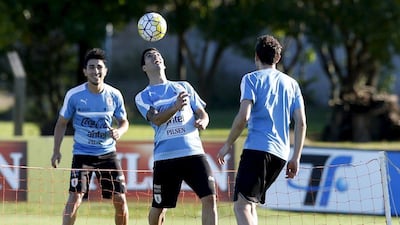 Uruguay's national team players Luis Suarez, centre, Jorge Fucile, left, and Christian Stuani participate in a training session in preparation for qualifying matches against Brazil and Peru. REUTERS/Andres Stapff