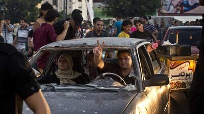 beaming women and children flashed victory signs and crowds of young men bounced up and down on rooftops, waving flags. Roberto Schmidt/AFP Photo