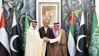 Pakistani Foreign Minister Shah Qureshi, centre, joins hands with UAE's Minister of Foreign Affairs, Sheikh Abdullah bin Zayed, left, and Saudi Foreign Minister Adel A lJubeir in Islamabad. AFP