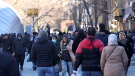 People walk at the Tehran Grand Bazaar on Tuesday following protests over a plunge in the currency's value. Reuters