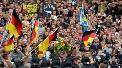 Protesters carry a wreath as they gather for a far-right protest in Chemnitz, Germany. AP